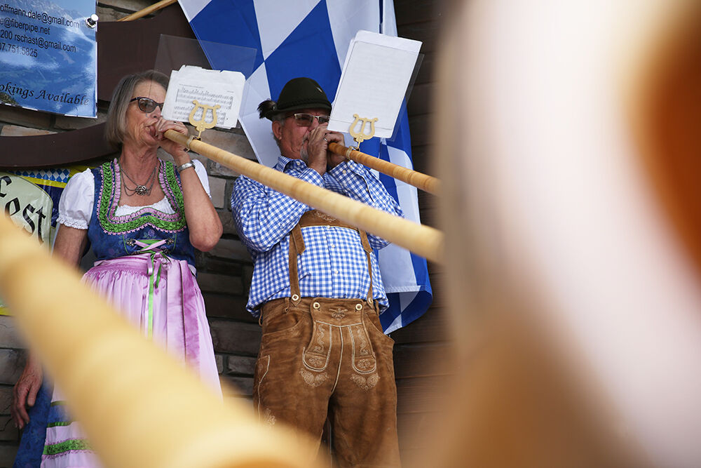 Kerry and Dale Hoffmann perform on their Alphorns beside fellow players